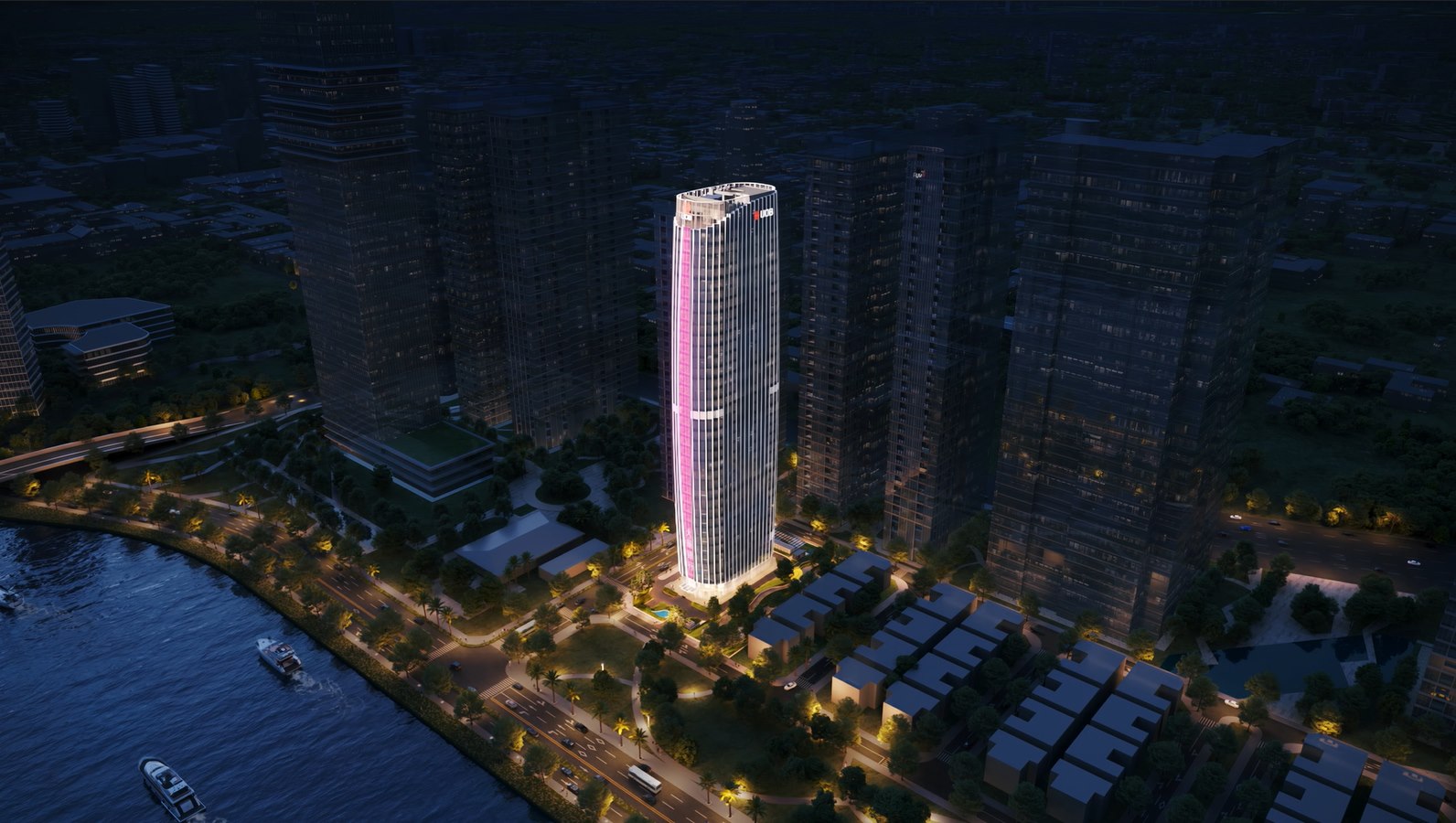 UOB Plaza HCMC illuminated at night beside the Saigon River